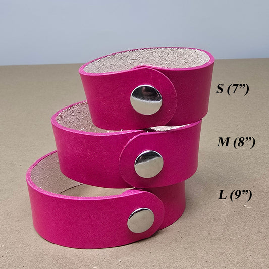 Close-up of hot pink natural vegetable tanned leather bracelet with smooth surface, ideal for tooling, stamping, or laser engraving custom designs.