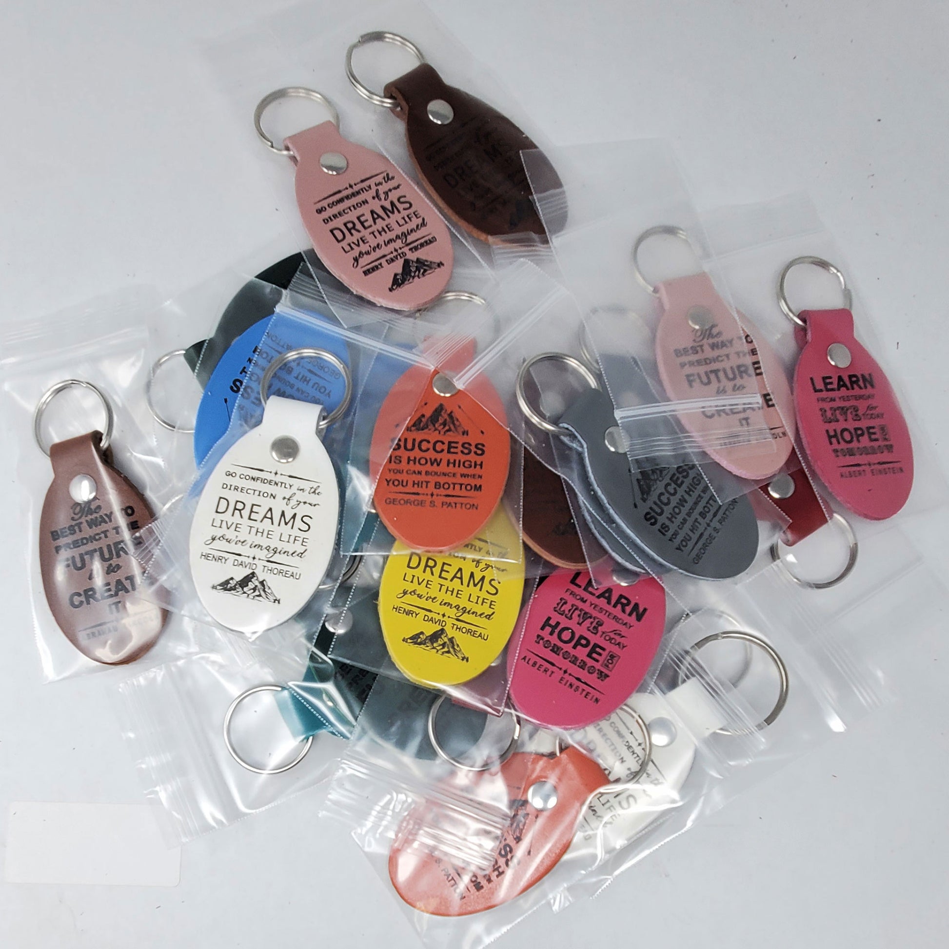 Motivational keychains laser engraved with inspiring quotes and designs for daily encouragement and positivity.
